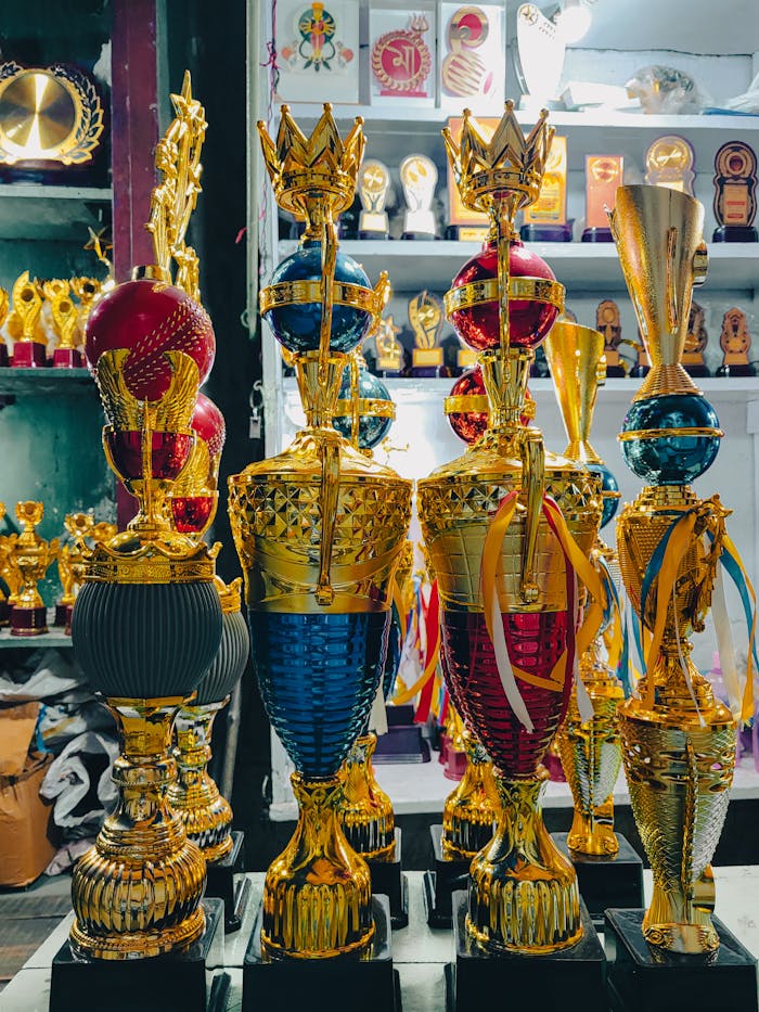About A vibrant array of golden trophies showcased in a Kolkata awards shop.